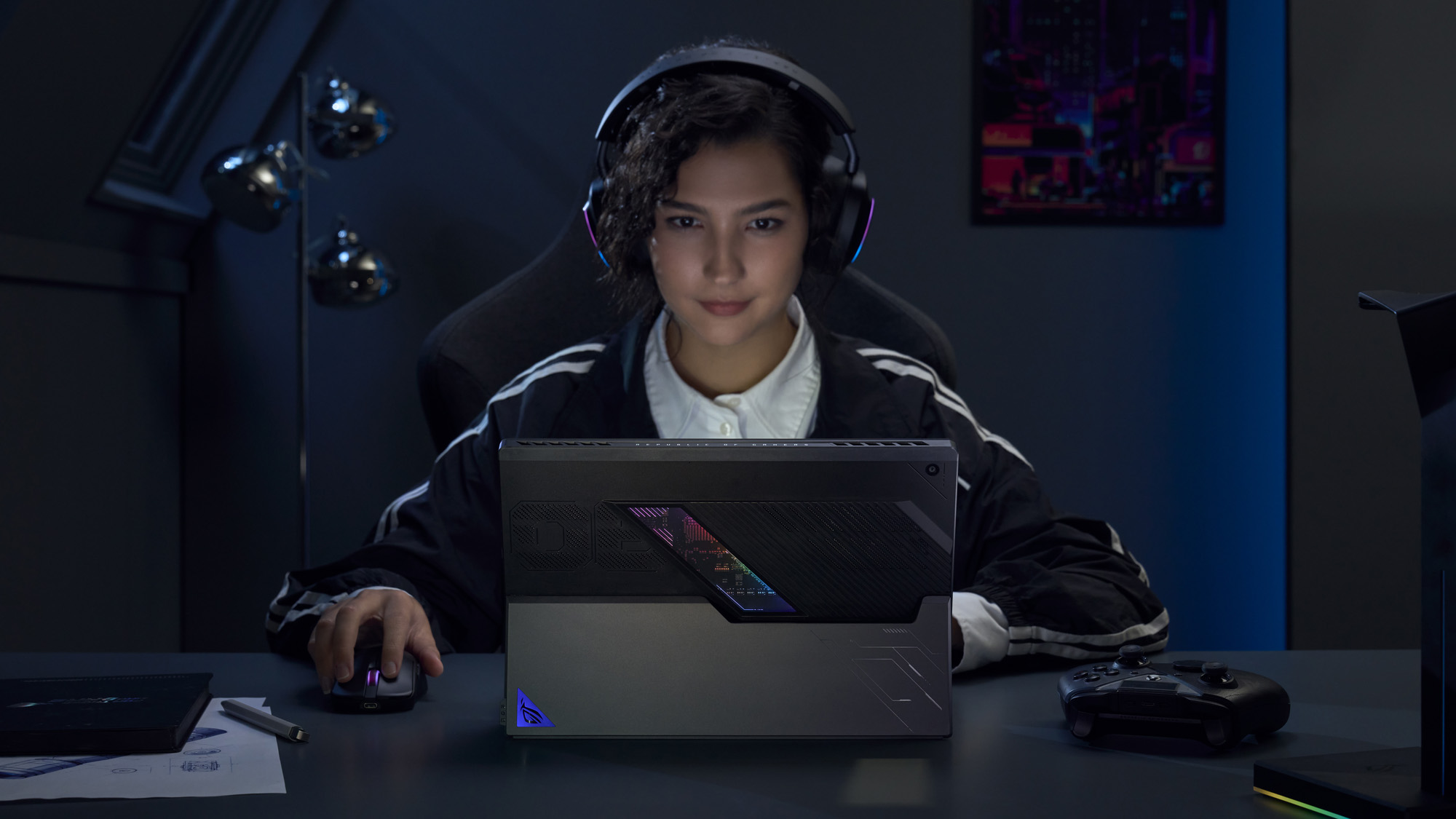 A woman using the ROG Flow Z13 in a dark room.