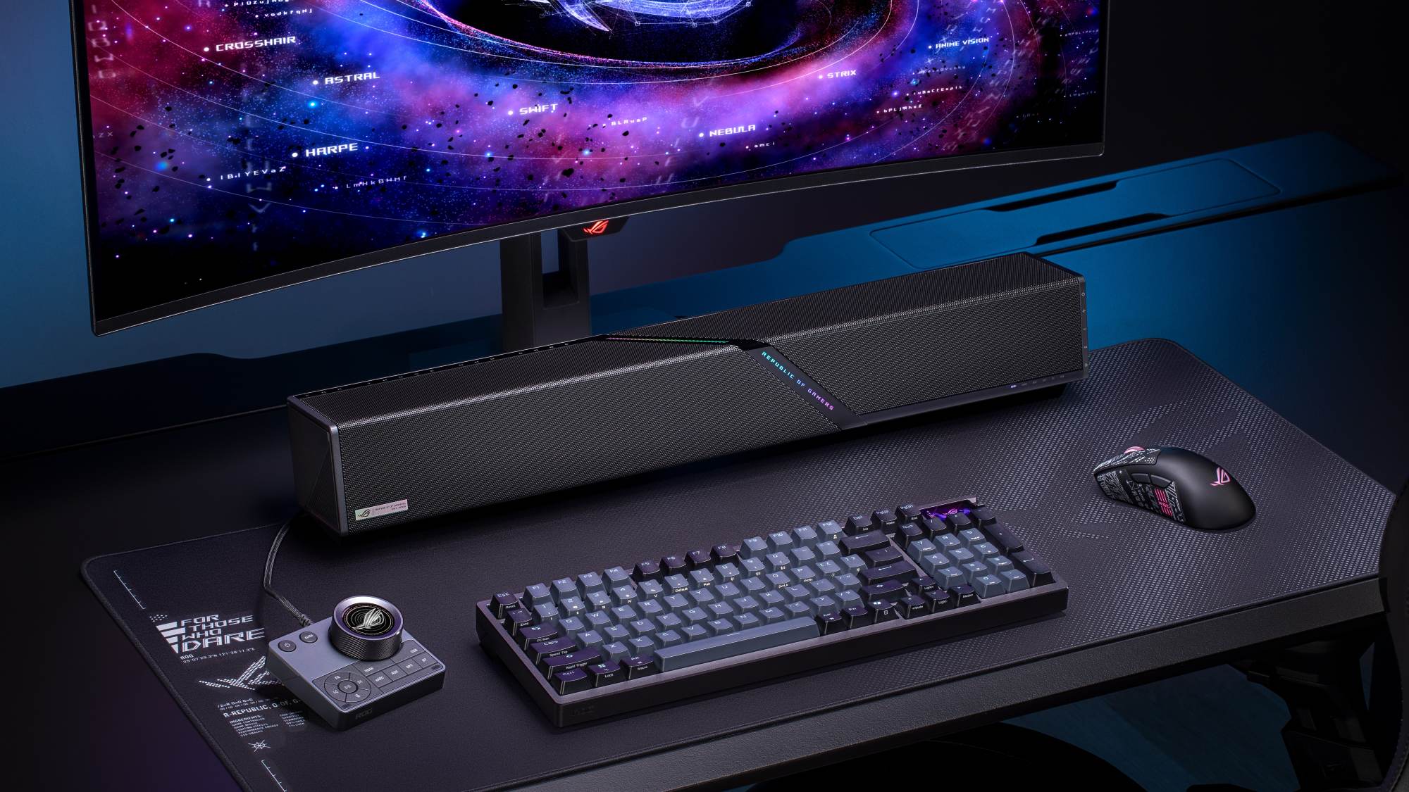 The ROG Gjallar gaming soundbar on a black desk surrounded by ROG gear.